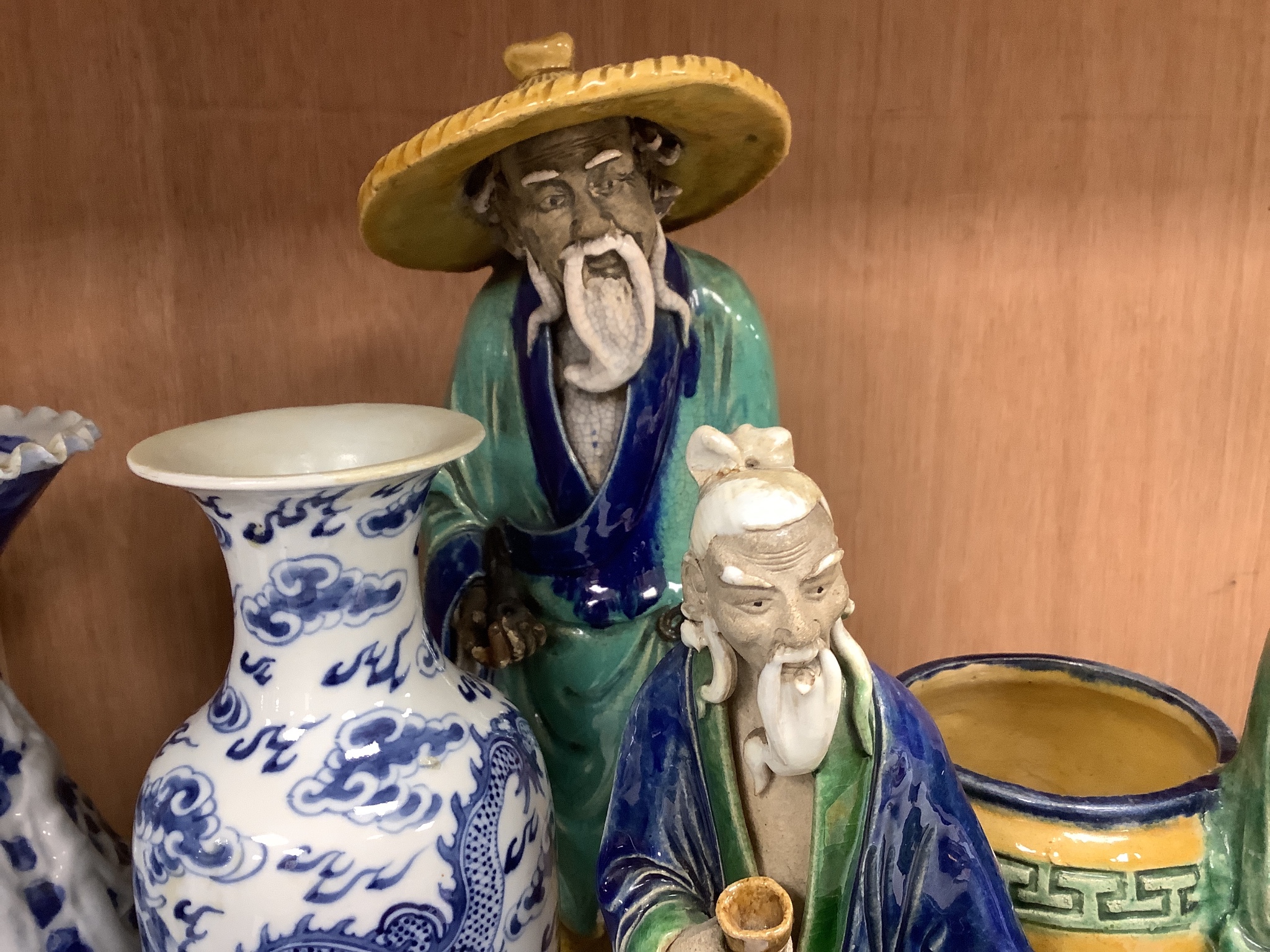 A collection of Chinese vases pottery figures and a compressed tea block, tallest piece 35cm